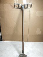 Full view of folded aluminum shooting stick seat showing twin seat panels and shaft