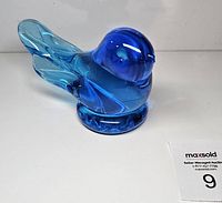 Left-side view of blue glass bird showing body and tail