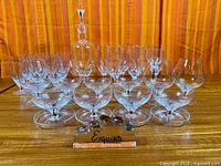 Full set arranged: 18 glasses, decanter and display block