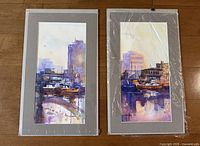 Both watercolor paintings side-by-side under mats