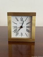 Front view showing dial, brand name, Roman numerals, hands