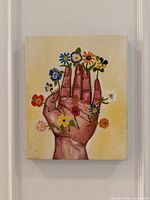 Front view of the painting showing hand and flowers composition