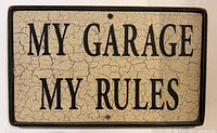 Front view of rectangular metal sign showing full text and crackle finish