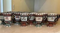 Front and side view of grouped pedestal mugs showing set size and uniform design