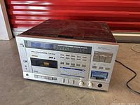 Front view of Lloyds stereo system showing tuner display, cassette deck, equalizer and controls