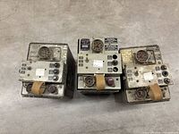 Top view of three power supply units showing control panels, sockets, labels, straps