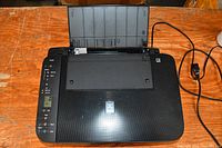 Top view of Canon TS3125 printer with lid closed and rear paper tray raised