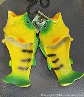 Top view of both fish sandals with tag and hook visible