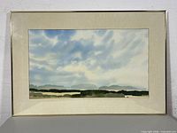 Full view of framed watercolour painting in metal frame with mat