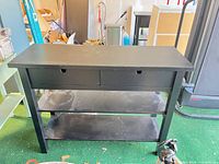 Front view of console table showing drawers and two shelves