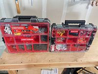 Both Craftsman organizers closed showing size difference and contents through clear lids
