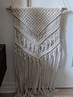 Full view of macrame wall hanging showing overall design and length