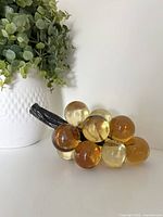 Front view of lucite grape cluster displaying amber and yellow spheres with stem