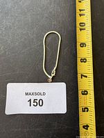 Full view of bracelet beside measuring tape showing length