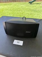 Front view of Bose DS 16SE speaker on table