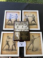 Overall lot showing plaque centered among four framed prints