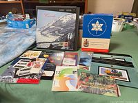 Overall lot showing albums, blue presentation box, souvenir sheets and loose stamps