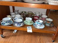 Shelf with approx. 15 assorted tea cup and saucer sets, various patterns and colours