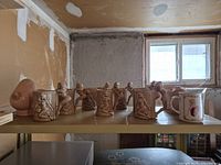 shelf with breast-shaped mug, eight nude relief mugs, Varga Girl mug