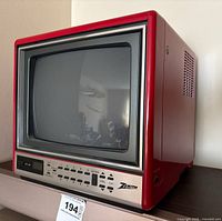 Front view of Zenith red CRT TV showing screen, control panel and brand logo