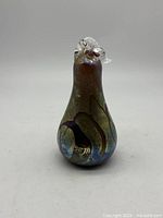 Front view of iridescent Alum Bay Glass pear sculpture