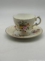 Side view of Cauldon floral teacup on matching saucer