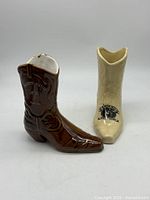 Both ceramic boot planters side by side showing overall form.