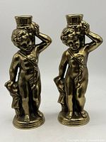 Front view of both cherub candlesticks