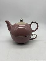 Side view showing teapot stacked on cup