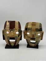 Front view of both stone masks on stands