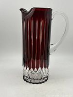 Front view of red crystal pitcher showing vertical cuts and clear spout