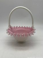 Front view of Fenton Pink Crest basket showing ruffled rim and handle