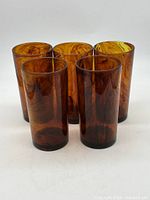Front view of five amber faux tortoiseshell glasses