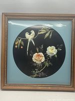 Full view of framed mother of pearl bird and rose art