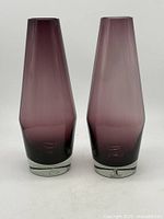 Two matching purple Riihimäki Suomi vases standing side by side