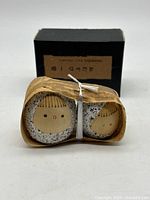 pair of kokeshi dolls in bamboo sheath with box behind