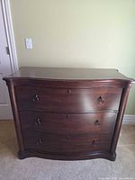 Front view of entire dresser showing drawers, pulls, overall shape and condition