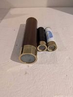 Three kaleidoscopes showing overall size difference and brass ends