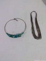 Both necklaces laid flat for full view and comparison