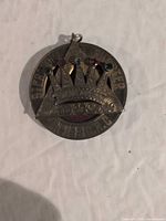 Front of sterling silver Masonic pendant showing crown motif and coloured stones