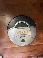 Top view of iRobot Roomba showing body, control buttons, and wear