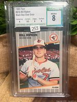 Front of encapsulated 1989 Fleer Bill Ripken card showing player image and CSG grade label