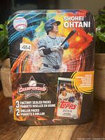 Front of sealed Shohei Ohtani Championship Collection tin showing branding and contents callout