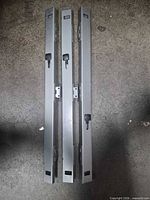 Three steel side-mount drawer slide rails silver/gray
