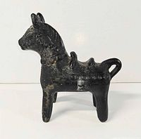 Left profile of black ceramic horse figurine