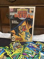 Front view of bagged Blue Beetle #20 comic and spread of X-Force cards