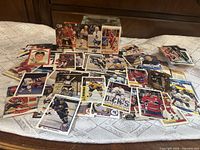 Pile of assorted NHL hockey cards spread on table