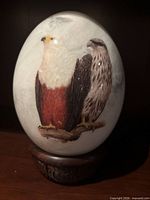 Front view of eagle egg sculpture showing two perched eagles