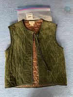 Front view of quilted vest showing brand label and overall colour