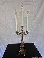 Full view of brass candelabra showing four lights and overall design